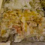 ...e una pittura in cui si intravede Cristo in abito porpora che regge la croce